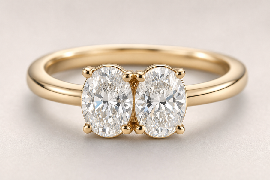 Close-up of a two stone diamond ring with two center stones on a gold band