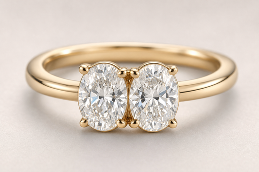Close-up of a two stone diamond ring with two center stones on a gold band