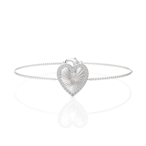 Heart-shaped centerpiece in polished 18K gold surrounded by round pavé lab diamonds on a delicate chain bracelet.