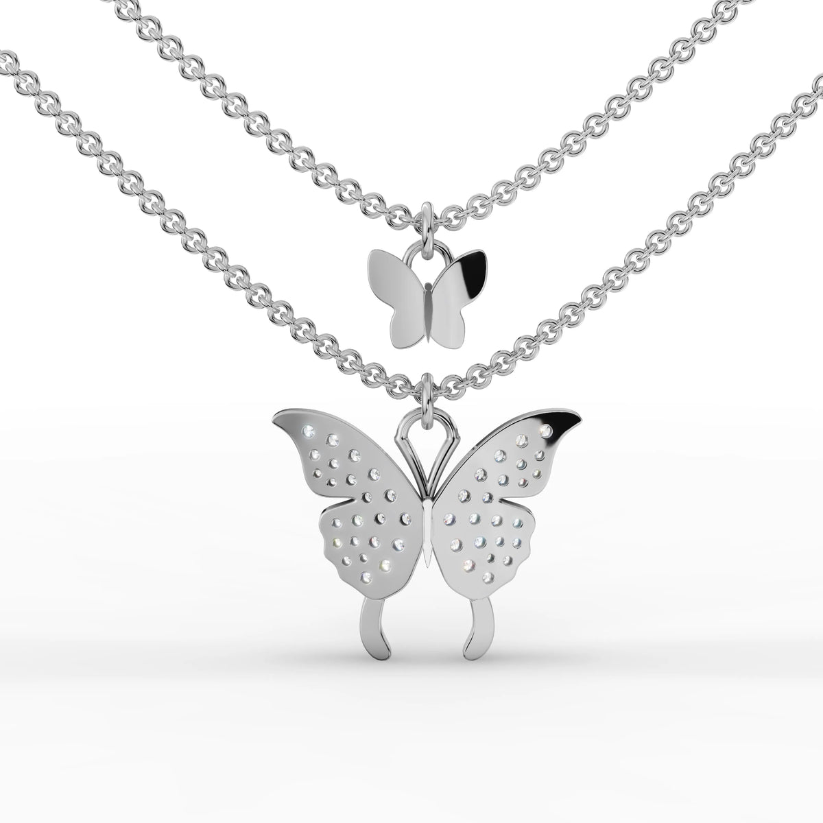 Double butterfly pendant in 18k gold featuring round brilliant lab diamonds; layered design on fine link chains.