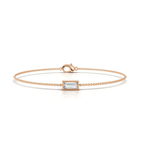 Delicate 18k gold bracelet featuring a center baguette lab-grown diamond in a rectangular setting, with a polished finish.
