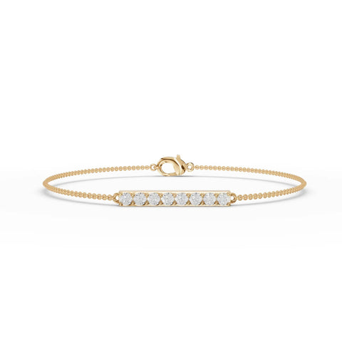Slim 18k gold bracelet featuring a straight bar of round lab diamonds, showcasing even sparkle and a delicate profile.