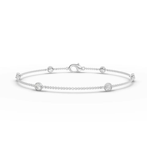 Delicate 0.60 Ct round bezel lab diamond bracelet in 18k gold featuring polished bead links and low-profile design.