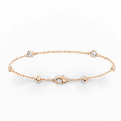 Refined 0.60 Ct round bezel lab diamond bracelet in 18k gold with polished bead links, showcasing a smooth, low-profile design.
