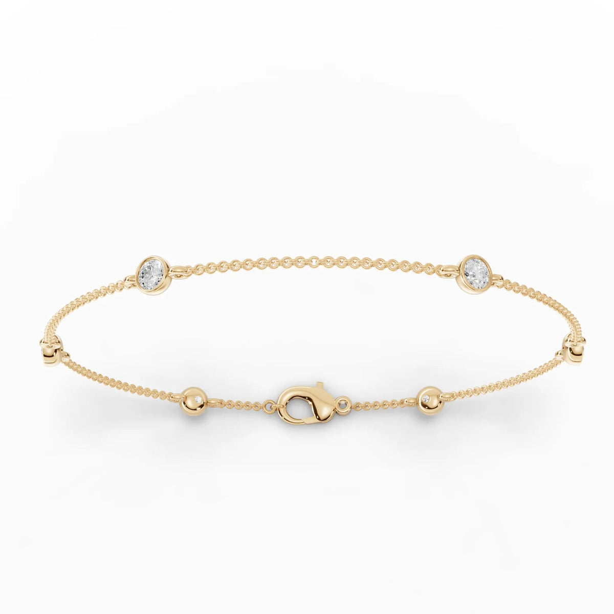18k gold bracelet featuring three round bezel-set lab grown diamonds and polished bead stations for a delicate, balanced design.