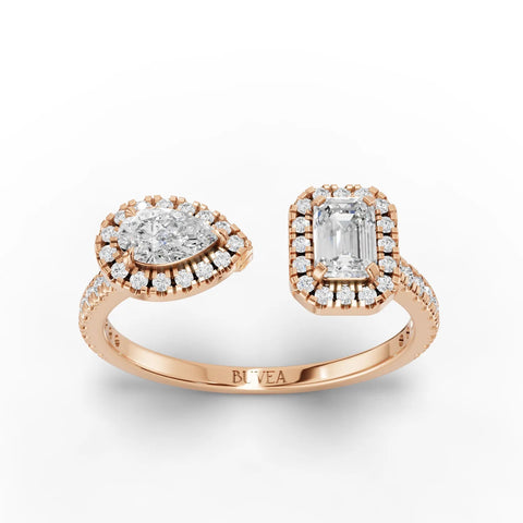 Two-stone halo lab diamond ring in 18K rose gold, featuring a pear and emerald-cut diamond in open design with halo accents.