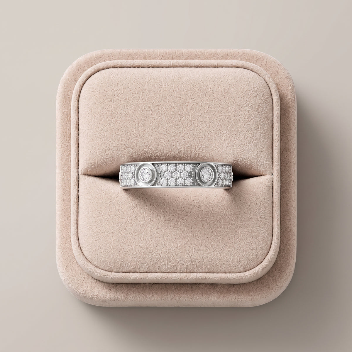 Wide 18K gold band featuring round lab grown diamonds in bezel and pavé settings, presented against a soft pink display.