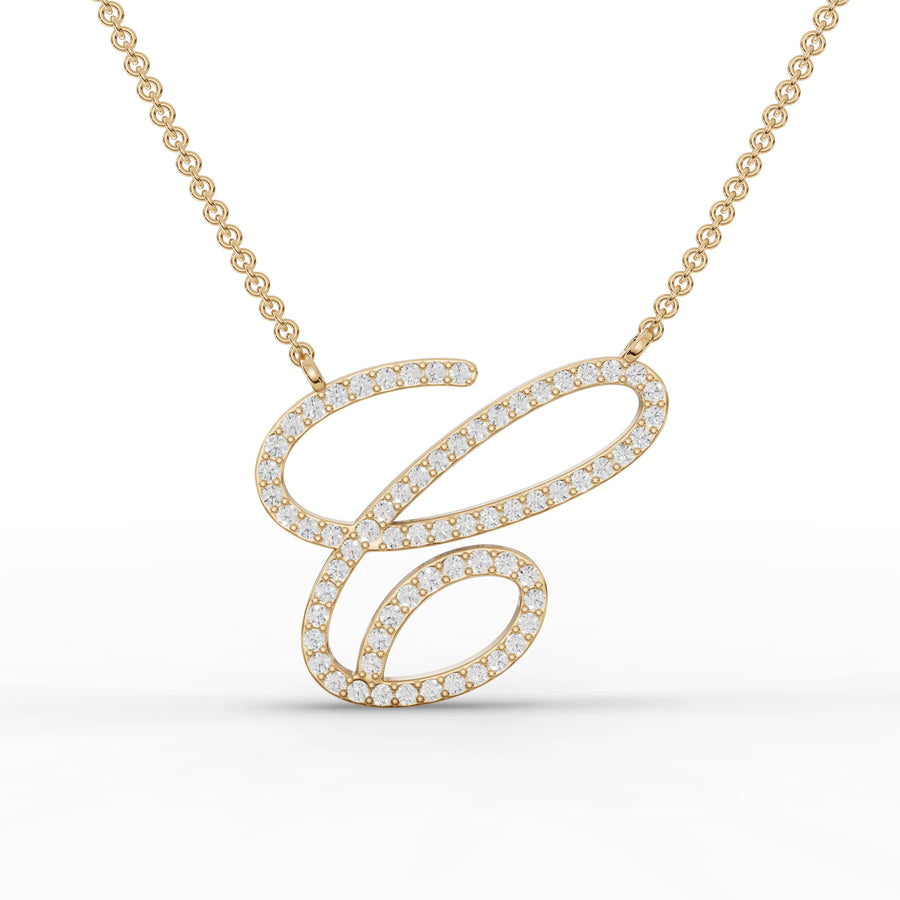 Round lab-grown diamond initial pendant with a cursive 'C', set in an 18k gold frame on a delicate chain.