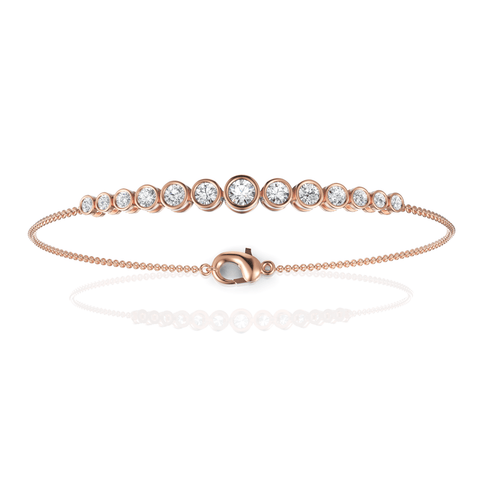 Round bezel lab diamond bracelet in rose gold with graduated stones and a delicate chain, featuring a lobster clasp.
