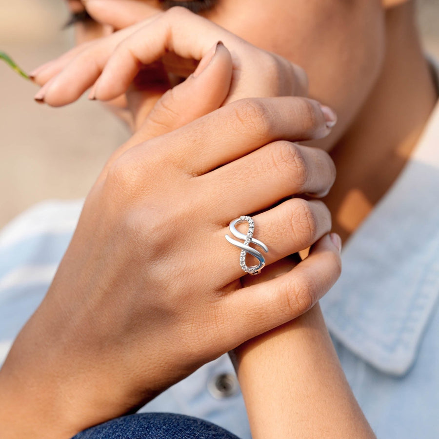 0.26 CT infinity loop diamond ring worn on hand