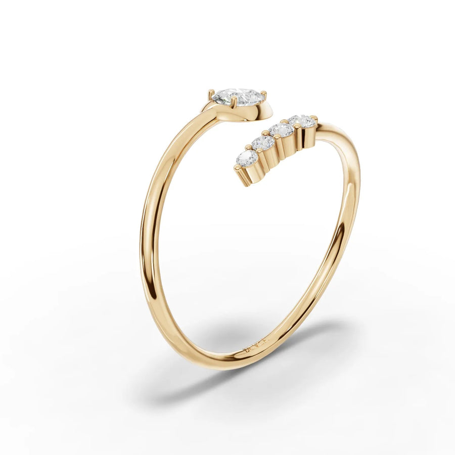 Pear diamond and round stones yellow gold close-up