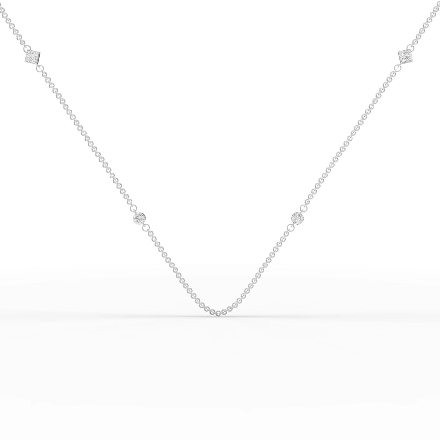 0.56 ct round and princess cut lab diamond station necklace on a delicate gold chain