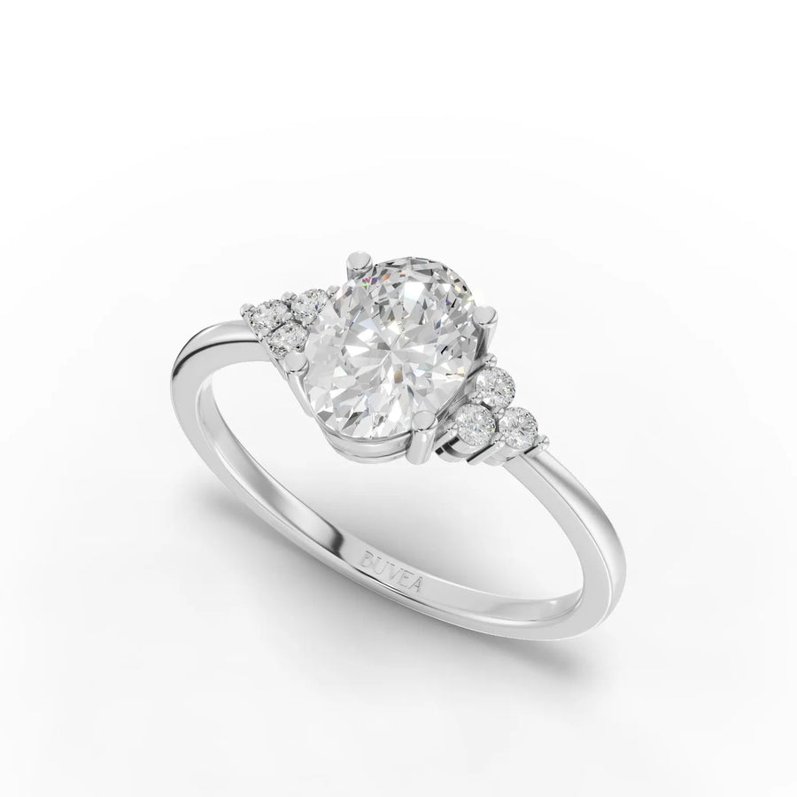 1.08 Ct oval lab grown diamond ring with round accent diamonds, set in a polished 18kt gold band, featuring a refined design.