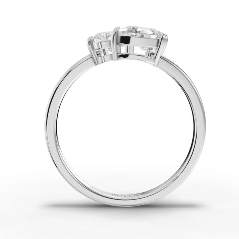 Three-stone lab grown diamond ring featuring an oval center, cushion-cut, and pear-shaped side diamonds in an 18K gold band.