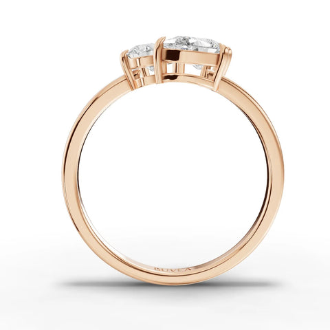 Three stone lab grown diamond ring featuring an oval center, cushion-cut and pear-shaped side stones, set in 18K gold.