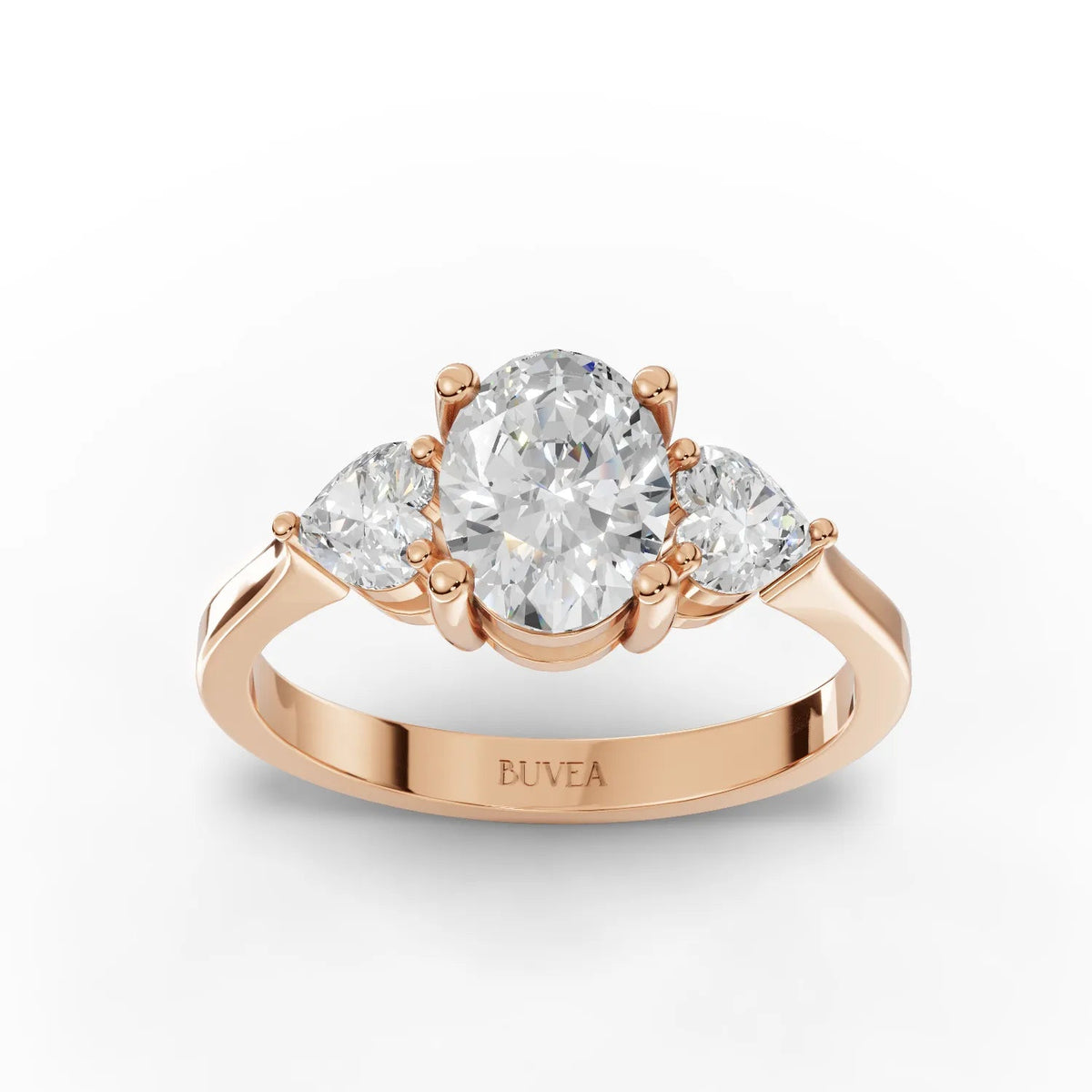 1.50 Ct oval three stone lab diamond ring in 18K rose gold, featuring a large oval center and two heart-shaped side stones.