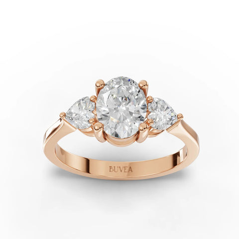 1.50 Ct oval three stone lab diamond ring in 18K rose gold, featuring a large oval center and two heart-shaped side stones.