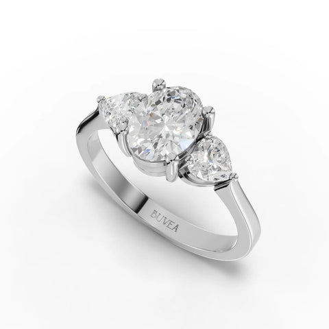 Elegant 1.50 Ct oval three-stone lab diamond ring in 18K gold, featuring a central oval diamond and two heart-shaped side stones.