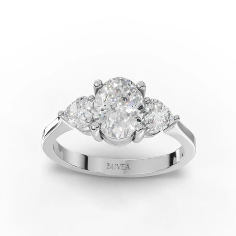 1.50 ct oval three stone lab diamond ring in 18K gold, featuring a central oval diamond and two heart-shaped side stones.