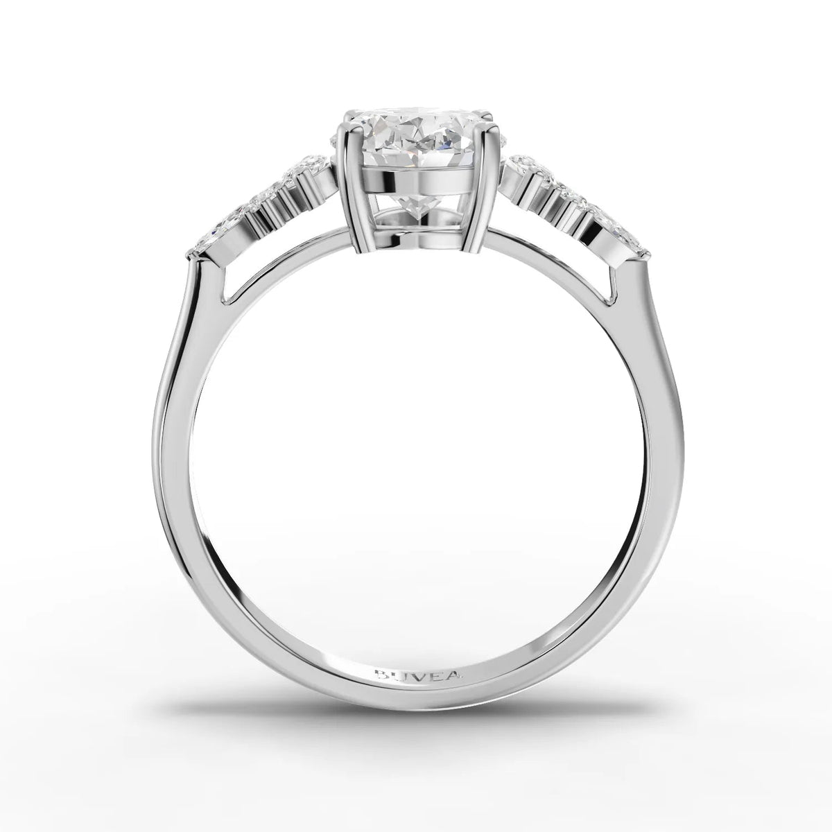 1.67 ct oval lab grown diamond ring in 18K gold, featuring marquise side stones and round accents in a three-stone design.