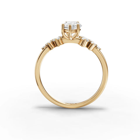 1.70 CT pear-shaped lab-grown diamond ring with round accent stones, set in a slender yellow gold band.