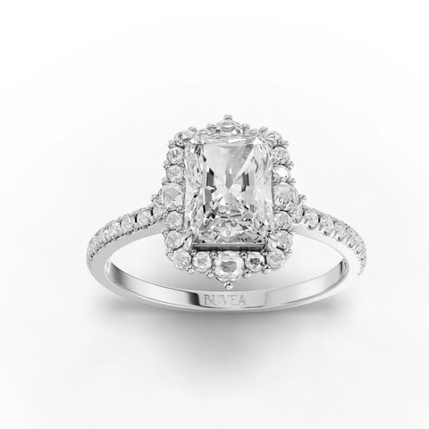 Radiant-cut center stone surrounded by a pavé halo on an 18K white gold band, featuring additional round diamonds.