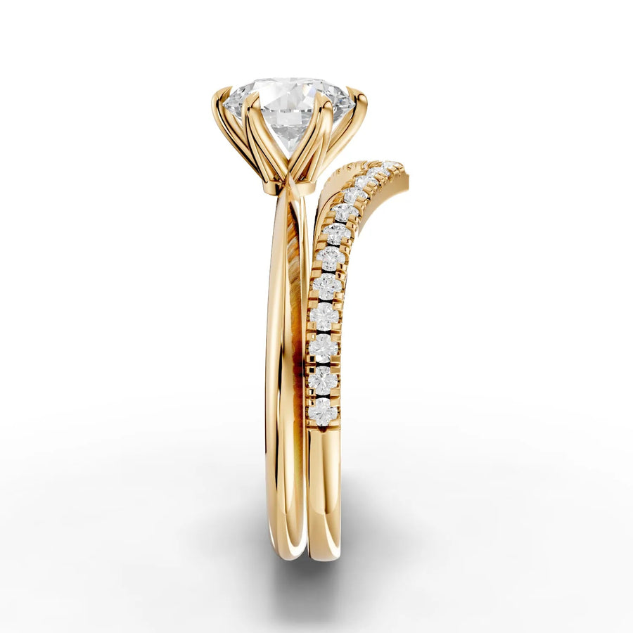 Round solitaire ring featuring a 1 ct center diamond in a six-prong setting, with a V-shaped band adorned with accent diamonds.