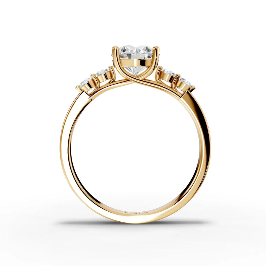 Round center three-stone ring yellow gold close-up