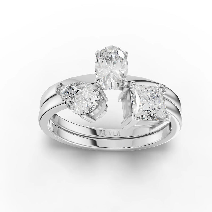 1.24 CT three stone lab diamond ring in 18K gold with oval center, pear side stone, and princess side stone