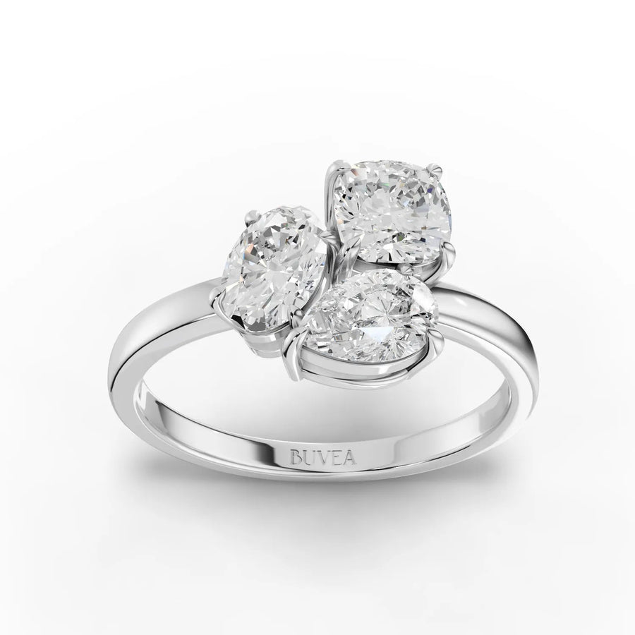 1.59 CT three stone lab grown diamond ring with oval, cushion, and pear diamonds set in 18K gold