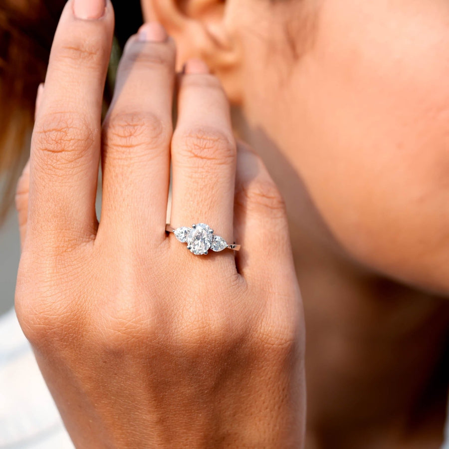 1.50 CT oval three-stone lab-grown diamond ring worn on hand