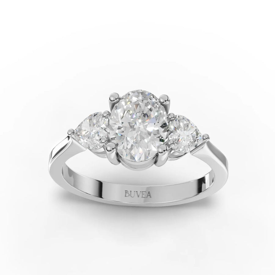 1.50 CT oval three stone lab diamond ring with 1 CT oval center, heart side stones, and 18K gold band