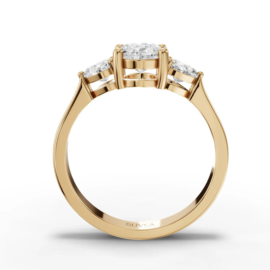Oval center heart side stone ring yellow gold close-up