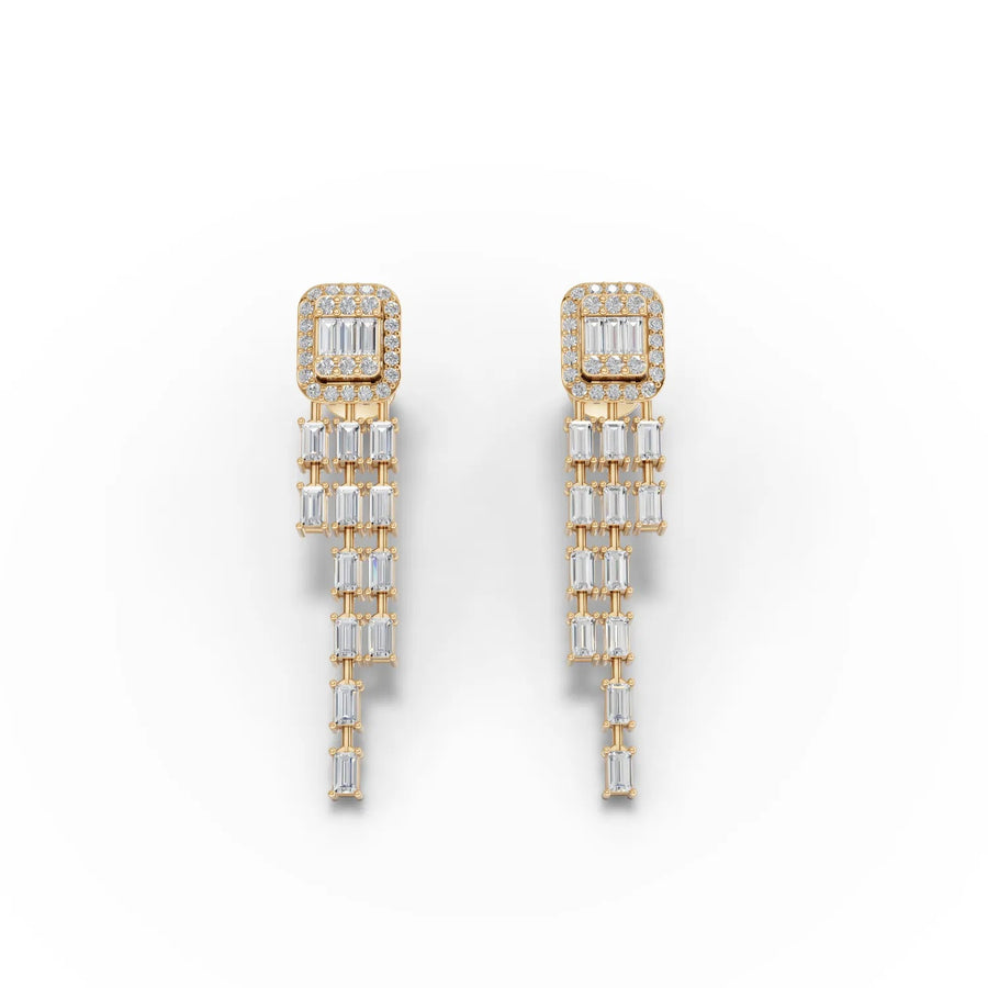 Baguette halo drop earrings feature a diamond-studded top and cascading baguette drops, all set in 18k gold.