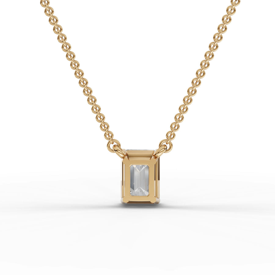 Lab-grown emerald pendant yellow gold close-up