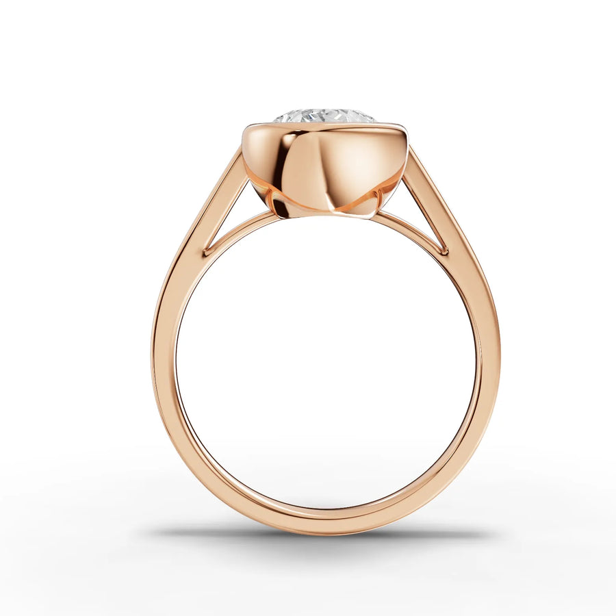 Bezel-set 2.50 Ct pear-cut lab diamond ring in rose gold, featuring a smooth, minimalist band design.