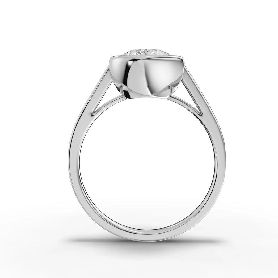 2.50 Ct pear-cut lab diamond ring in a smooth bezel setting, featuring a polished silver band and elegant profile.