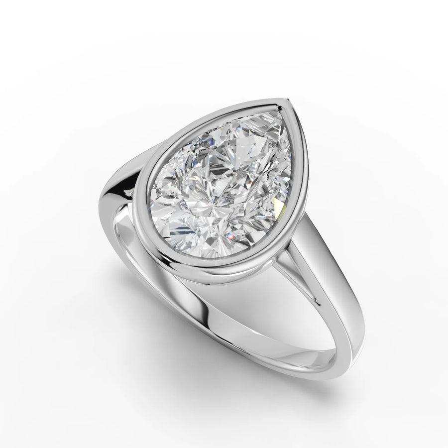 2.50 Ct pear-cut lab diamond set in a sleek, polished bezel ring; contemporary design with smooth, elegant band.