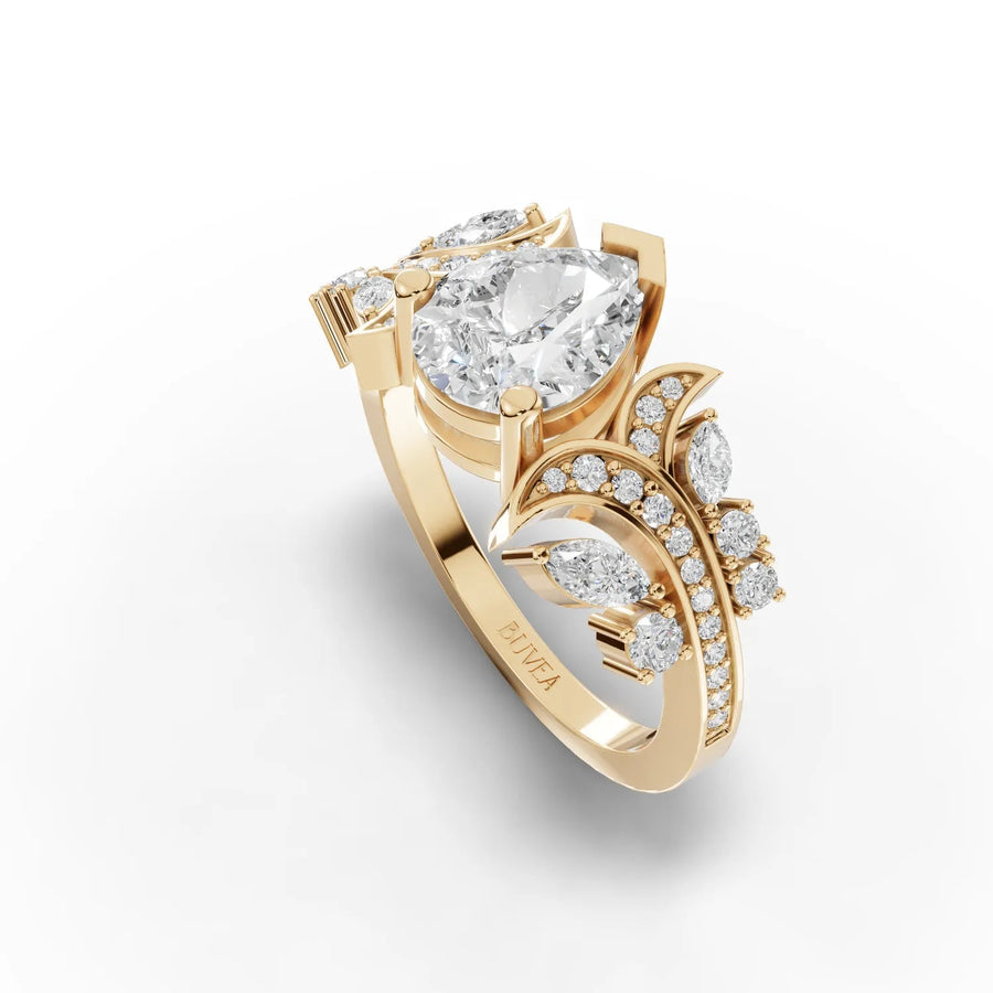 Pear accent diamond ring yellow gold top view