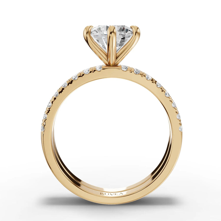 Lab grown diamond ring featuring a 1.5 CT round center stone with a gold band accented by small diamonds along the edges.