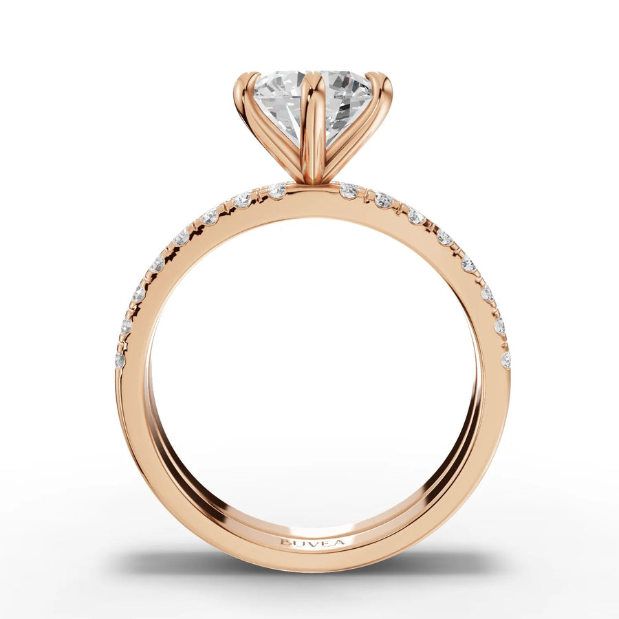 Lab grown diamond ring featuring a 1.5 CT round center stone with accent diamonds along a warm rose gold band.
