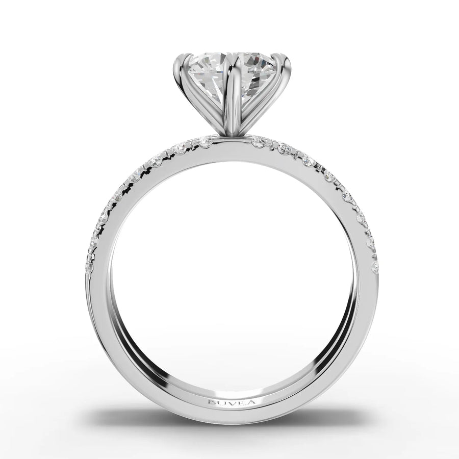 Round lab grown diamond ring features a 1.5 CT center stone and double row of accent diamonds on a polished gold band.