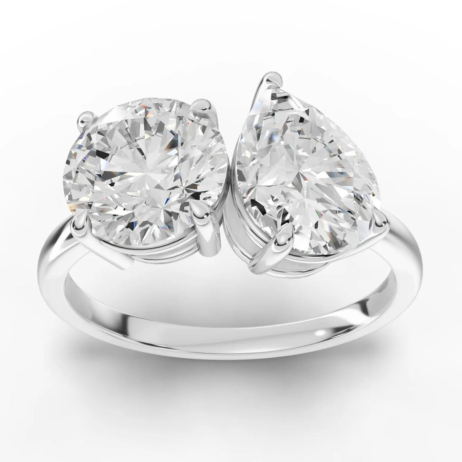 2.50 ct toi et moi lab-grown diamond ring with 1.50 ct round and 1.00 ct pear diamonds on a polished gold band