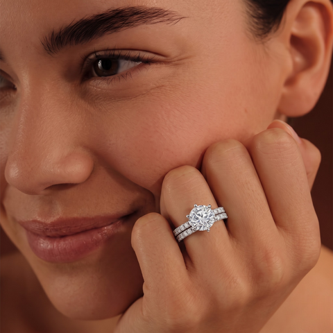 Round lab grown diamond ring set featuring a 1.5 CT center stone with accent diamonds on a textured gold band.