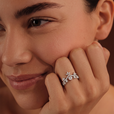Crown style 0.83 CT lab diamond ring featuring a round center stone and accented by small round diamonds in floral motifs.