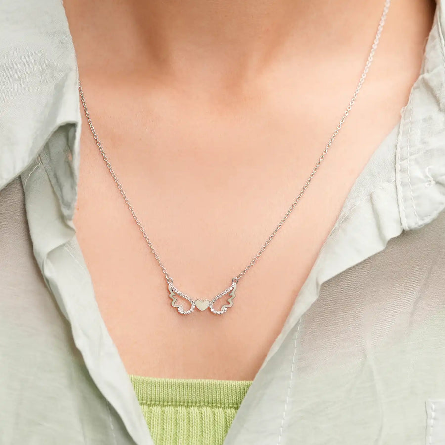 Model wearing heart wing stone pendant