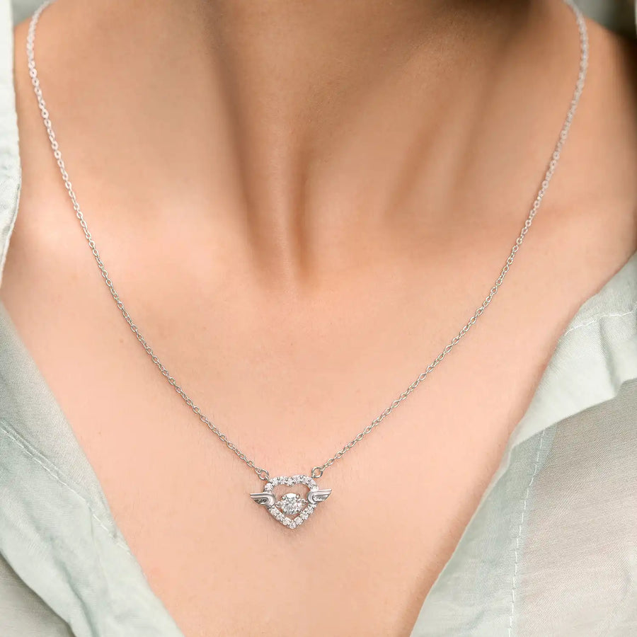 Model wearing heart wing diamond pendant