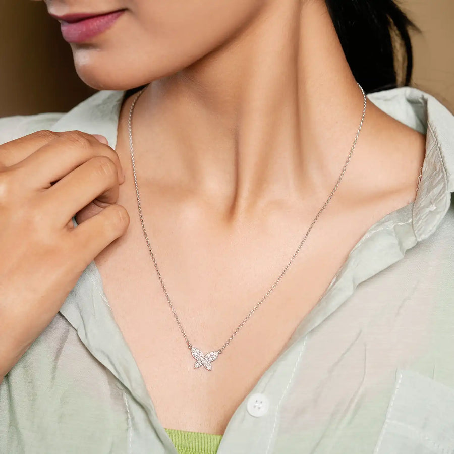 Close-up of pendant on model's neckline