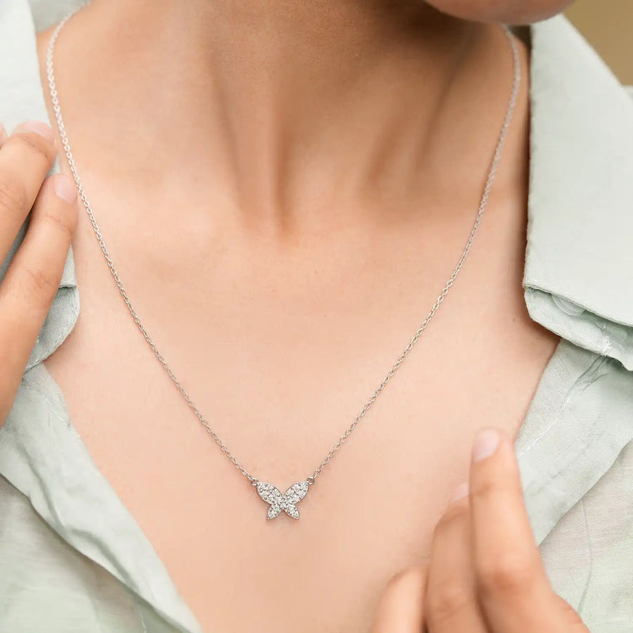 Model wearing butterfly diamond pendant
