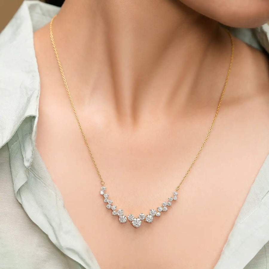 Model wearing graduated V diamond necklace